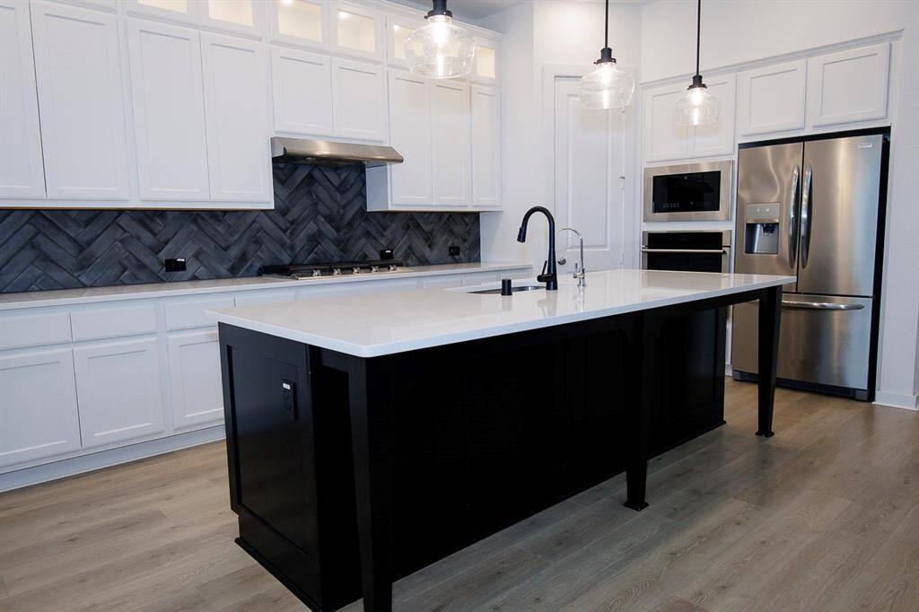 This kitchen features a stunning island, perfect for cooking and entertaining.