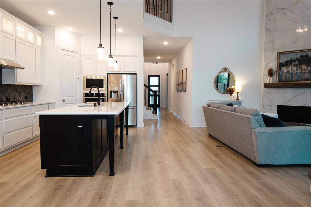 Experience seamless living in this stunning open-concept space, featuring a modern kitchen with sleek appliances, light-filled interiors, and a cozy living area perfect for entertaining.