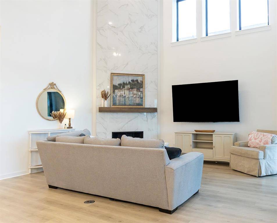 Experience warmth and elegance in this inviting living area, featuring a stunning fireplace centerpiece.