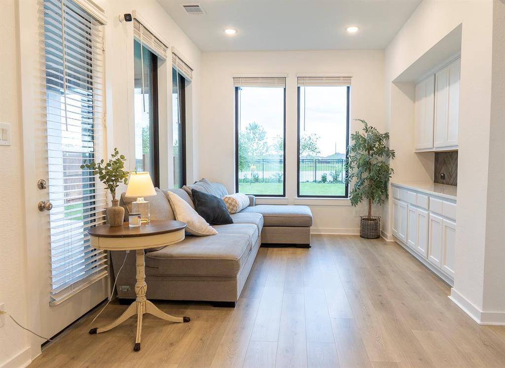 Bright and inviting sitting area with large windows, perfect for relaxation and enjoying the view.