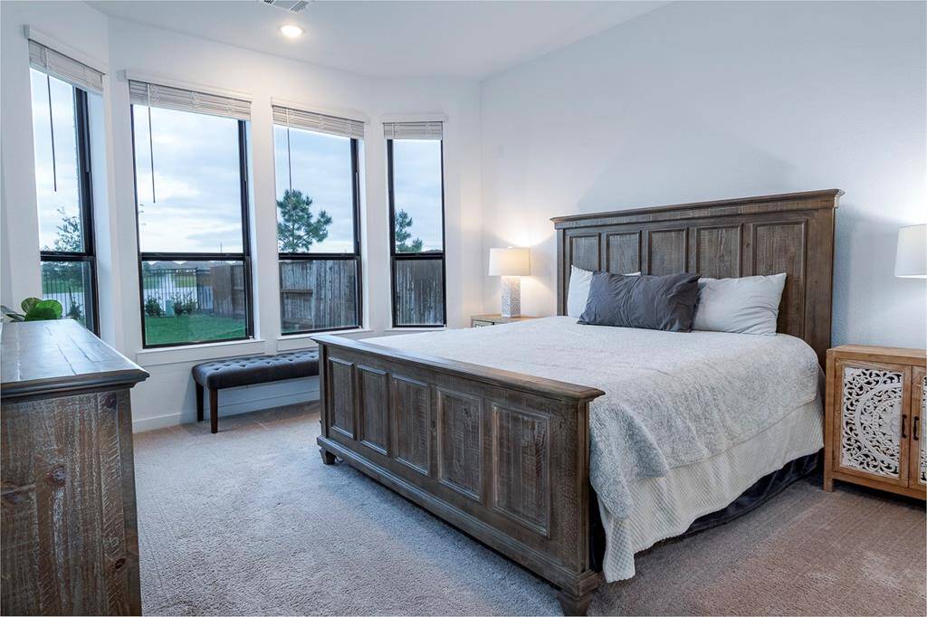 Bright and inviting primary bedroom with expansive windows offering stunning views.