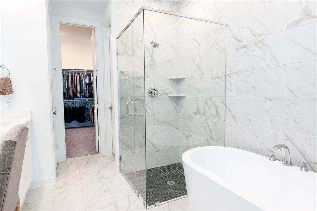 Luxurious bathroom featuring a separate shower and elegant bathtub for ultimate relaxation.