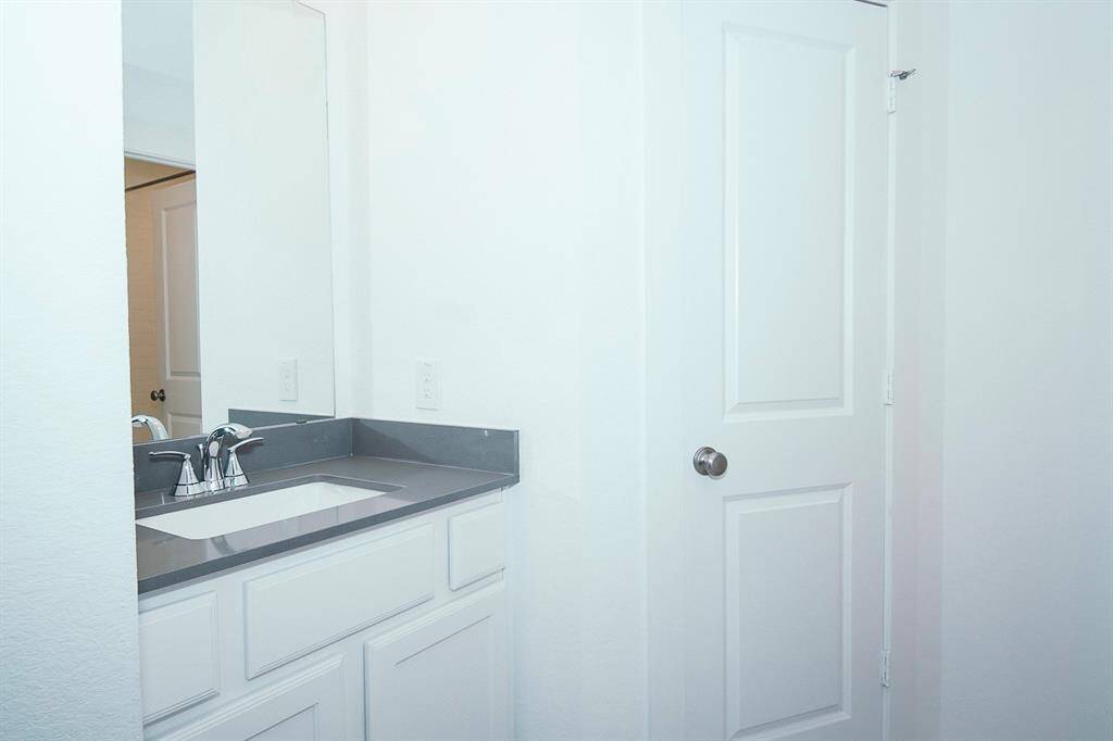 This stylish Jack and Jill bathroom offers convenience and privacy with its sleek design and modern fixtures, seamlessly connecting two bedrooms.