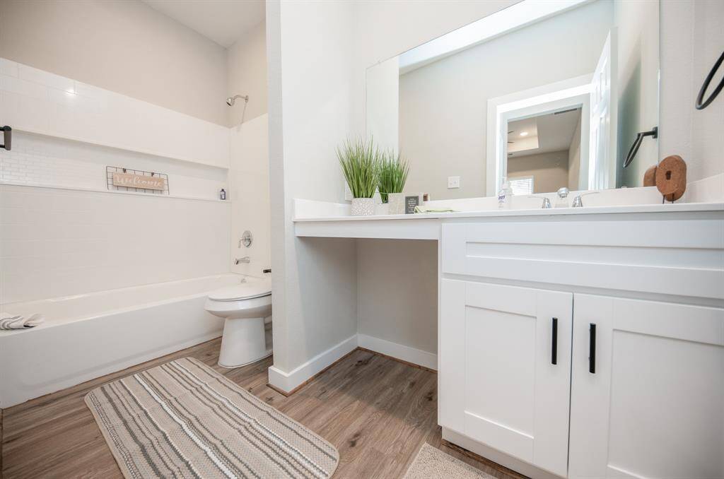 Primary bath with tub and shower combo along with vanity space