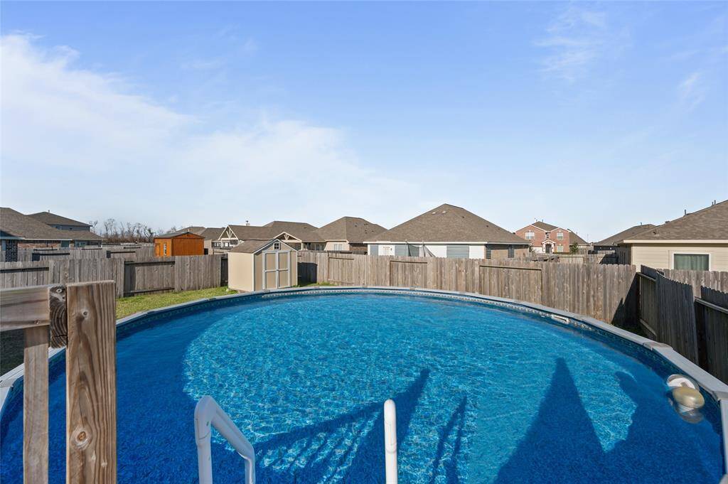 This backayrd features a spacious above-ground pool in a fenced backyard, providing a private and relaxing outdoor space. Ideal for family fun and entertaining.