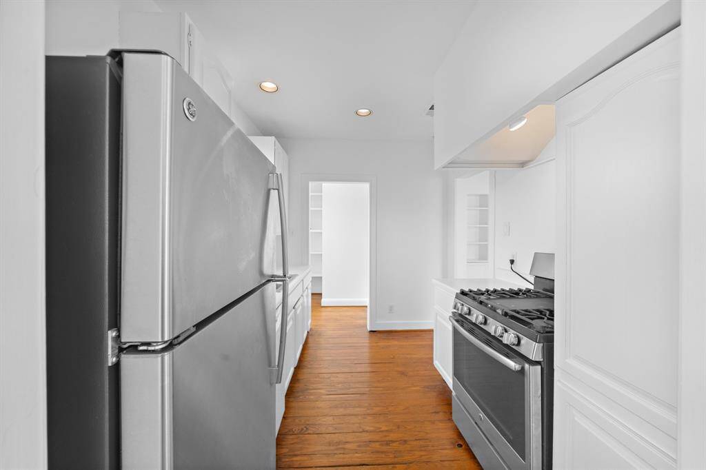 Pantry cabinet and a large utility room with extra storage.