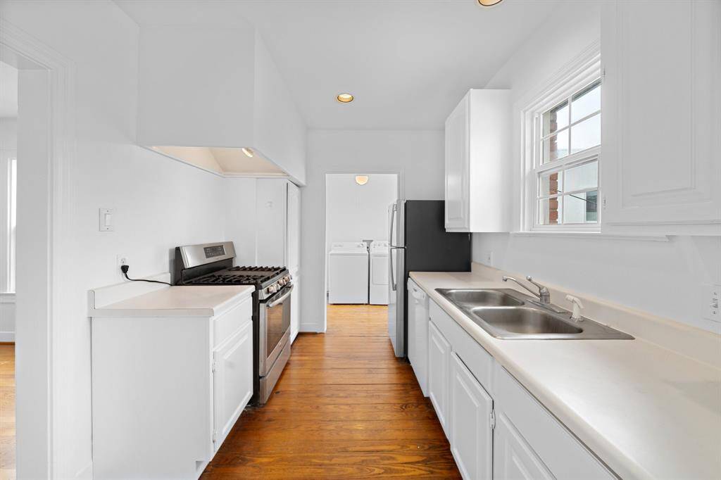 A view of the kitchen with the utility room next to it.