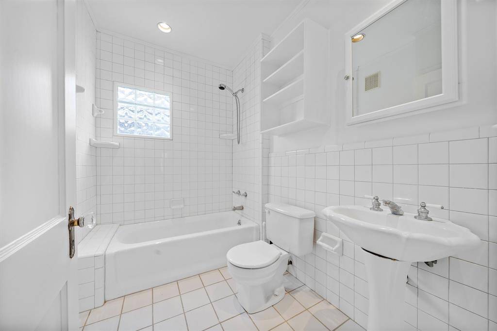 The bathroom has storage shelves and a medicine cabinet