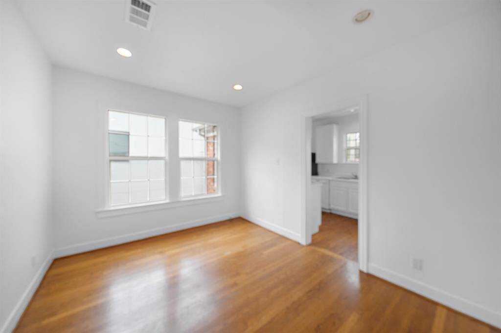 Dining room with double windows and adjacent to the kitchen.