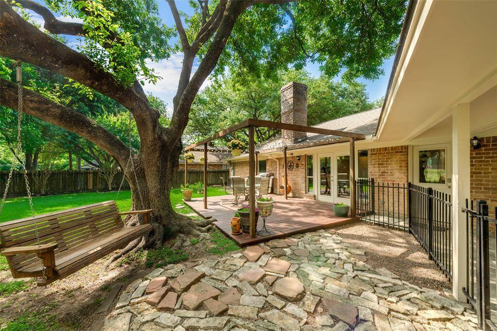 The porch swing does not stay, but this patio and yard are ready for outside time all year round.