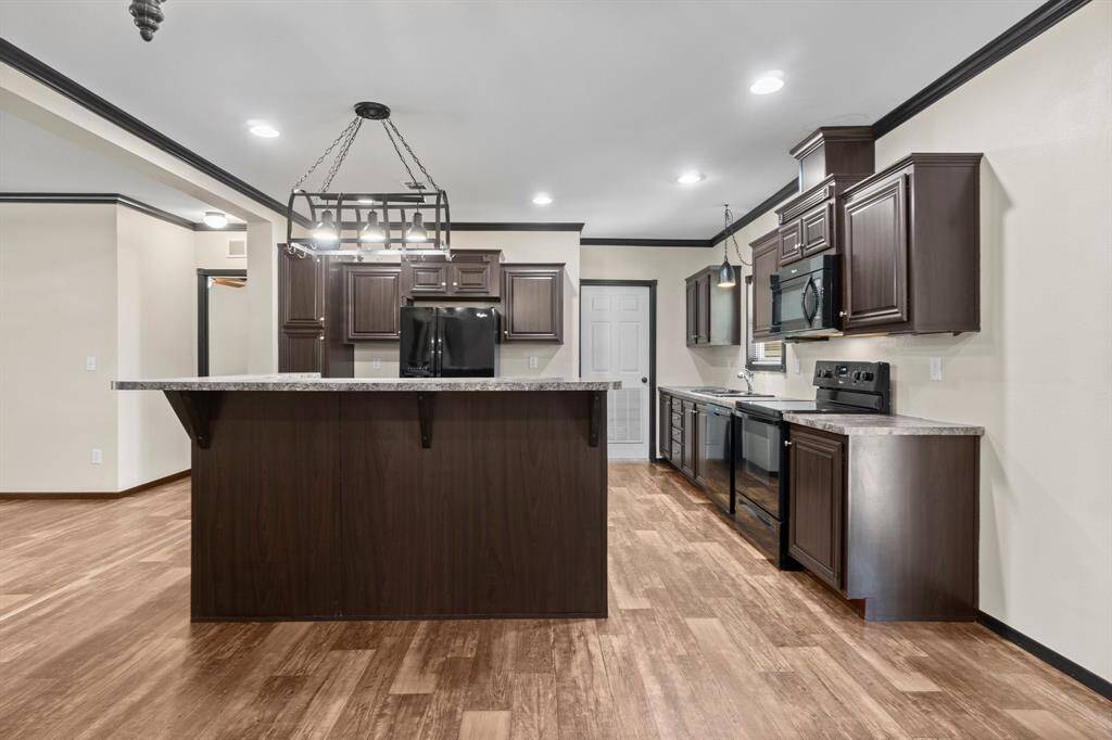 This modern kitchen offers a functional layout with ample storage and a convenient island, perfect for cooking and entertaining.