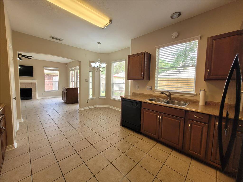Kitchen, Breakfast area leading to the Den with lots of light and fireplace