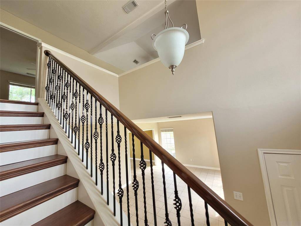 Attractive wood staircase with wrougt iron spindles