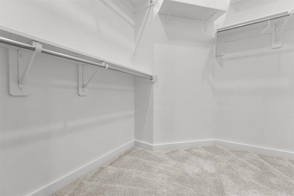 Master Walk-in Closet:“Spacious walk-in closet in the master suite, offering ample storage and organized shelving for your wardrobe.