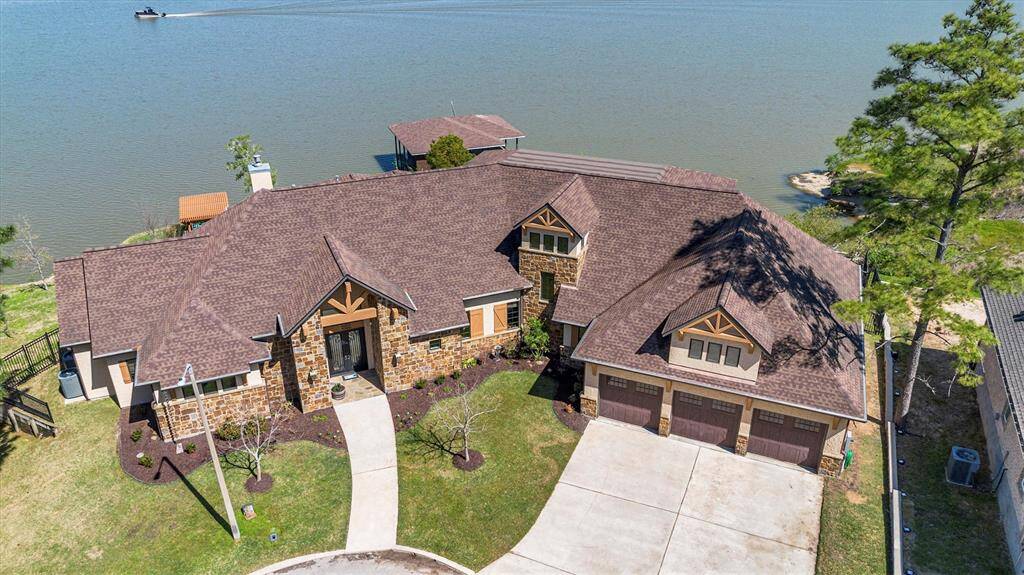 Welcome to lakeside luxury at its finest—this custom waterfront retreat combines high-end finishes with a floor plan designed for effortless entertaining. Featuring a spacious 4-car garage, sparkling pool and spa, and a covered summer kitchen, it’s built for hosting friends and family in style. The private boathouse includes 2 boat lifts, 2 jet ski lifts, a fish cleaning station, and dedicated gear storage—everything you need for the ultimate lakefront lifestyle.