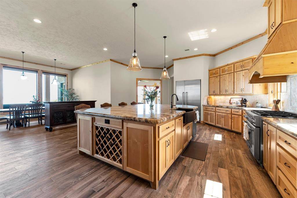 This expansive kitchen is designed for both everyday living and entertaining, featuring an oversized island with bar seating, ample workspace, and plenty of room for casual meals and snacks. Open to the family room, dining area, and nearby game room, it’s the perfect hub for everything from quiet mornings to lively gatherings.