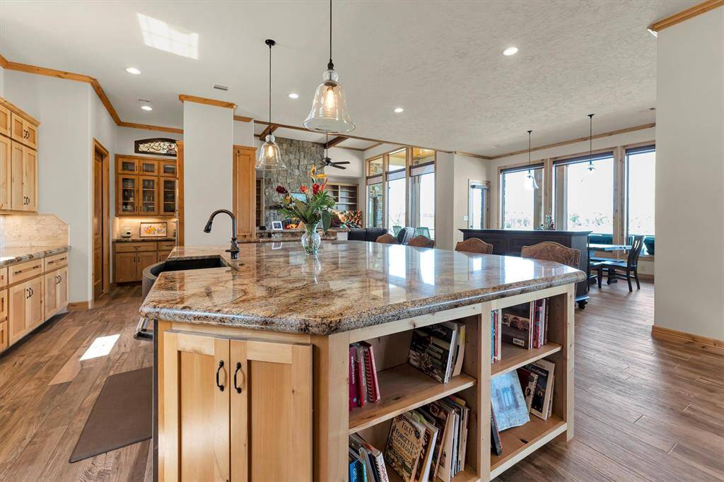 A chef’s dream, this beautifully designed kitchen combines sleek finishes with everyday functionality. Enjoy ample space for meal prep and cleanup, stainless steel appliances, granite countertops, and tile backsplash with under-cabinet lighting. A spacious butler’s pantry keeps everything organized, while the oversized island with bar seating is perfect for casual meals and easy entertaining.