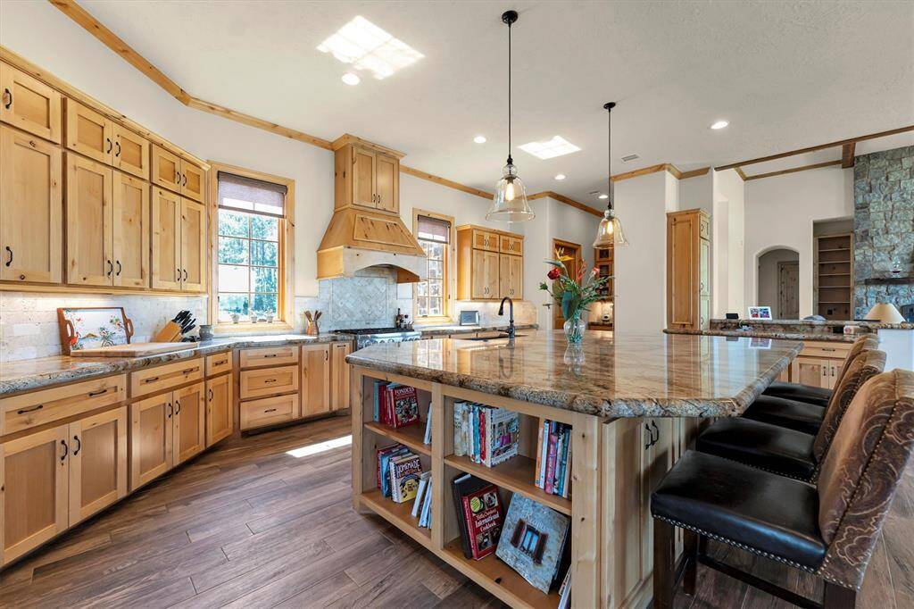 Step into this open chef’s kitchen, where style and function come together effortlessly. Designed for both everyday cooking and entertaining, it features premium stainless steel appliances, expansive granite countertops, and a large island with bar seating. A walk-in butler’s pantry, under-cabinet lighting, and seamless flow to the living and dining areas make it as practical as it is beautiful. Come find the hidden features that truly set it apart.