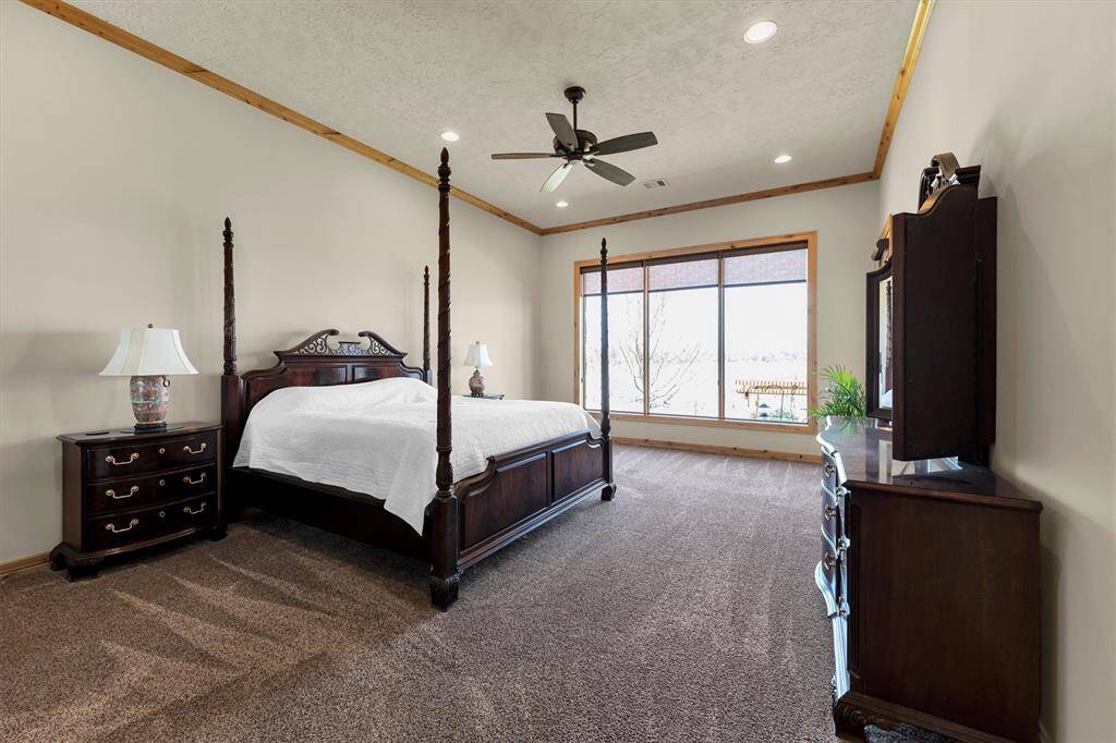 You’ll have sweet dreams in this luxurious owner’s retreat, featuring soft neutral finishes, serene lake views, and plenty of space to comfortably accommodate your California King bed and oversized furnishings.