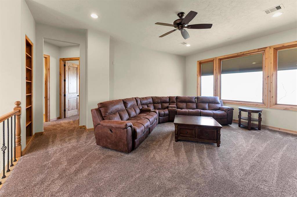 Imagine the possibilities in this expansive second-floor game room, where a wall of windows with custom shades frames breathtaking views. And with a second game room located downstairs, you can keep the party going on multiple levels, perfect for entertaining guests, relaxing with family, or creating fun, flexible spaces everyone will love.