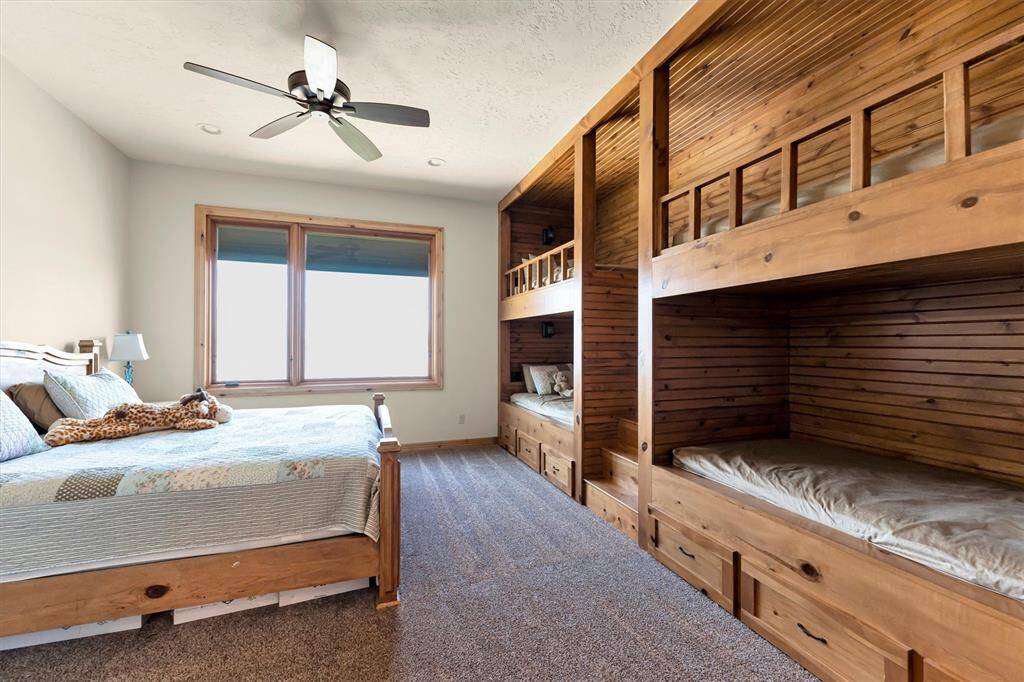 This charming guest suite offers built-in bunk beds for added flexibility, plus plenty of space for a king bed. Guests will enjoy the convenience of a walk-in closet and a private ensuite bathroom, making it the perfect blend of comfort and functionality.