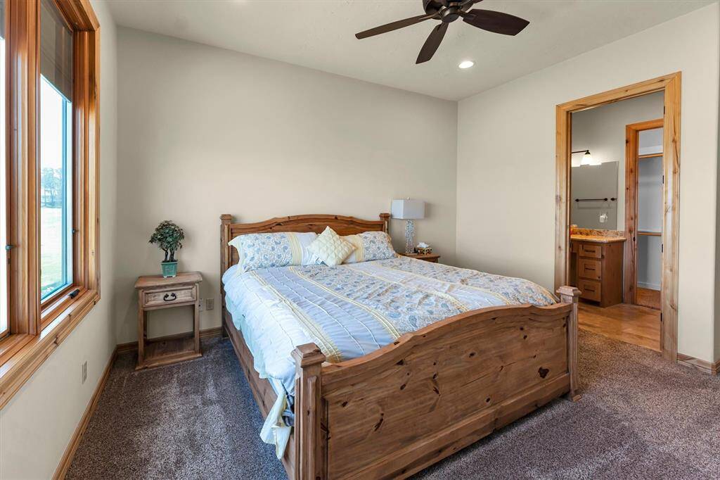 An alternate view of this spacious suite reveals plenty of room for large furnishings, games, toys, and more. With direct access to a generous walk-in closet and a pristine ensuite bathroom, comfort and functionality come standard.