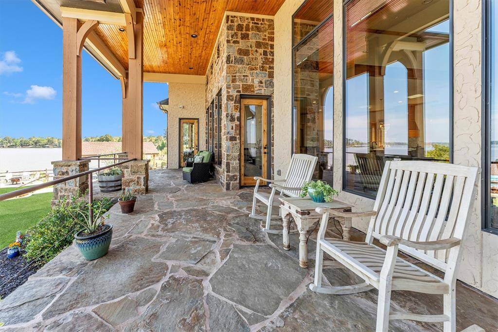 Whether you’re sipping sweet tea or sharing fish tales, this is lakeside living at its finest. You'll enjoy a healthy dose of Southern hospitality on this welcoming porch with views of the sparkling pool, tranquil lake, and lush surroundings