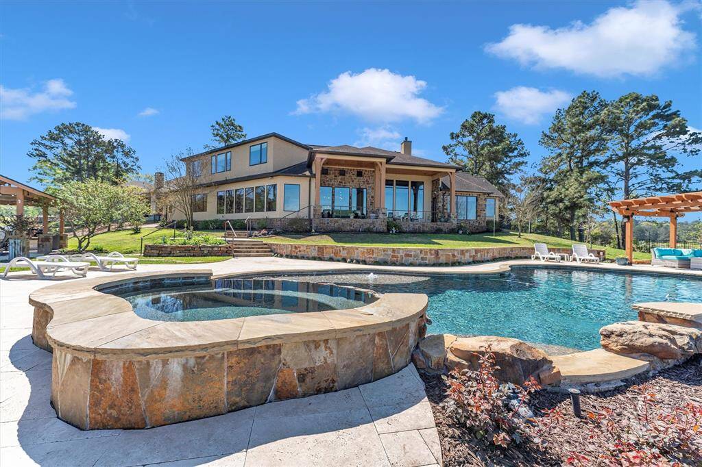 Enjoy the best of outdoor living with poolside lounging and effortless lakeside entertaining. This beautifully designed retreat features a sparkling heated pool, raised spa, and scenic lake views—perfect for relaxing under the sun or hosting unforgettable gatherings by the water.