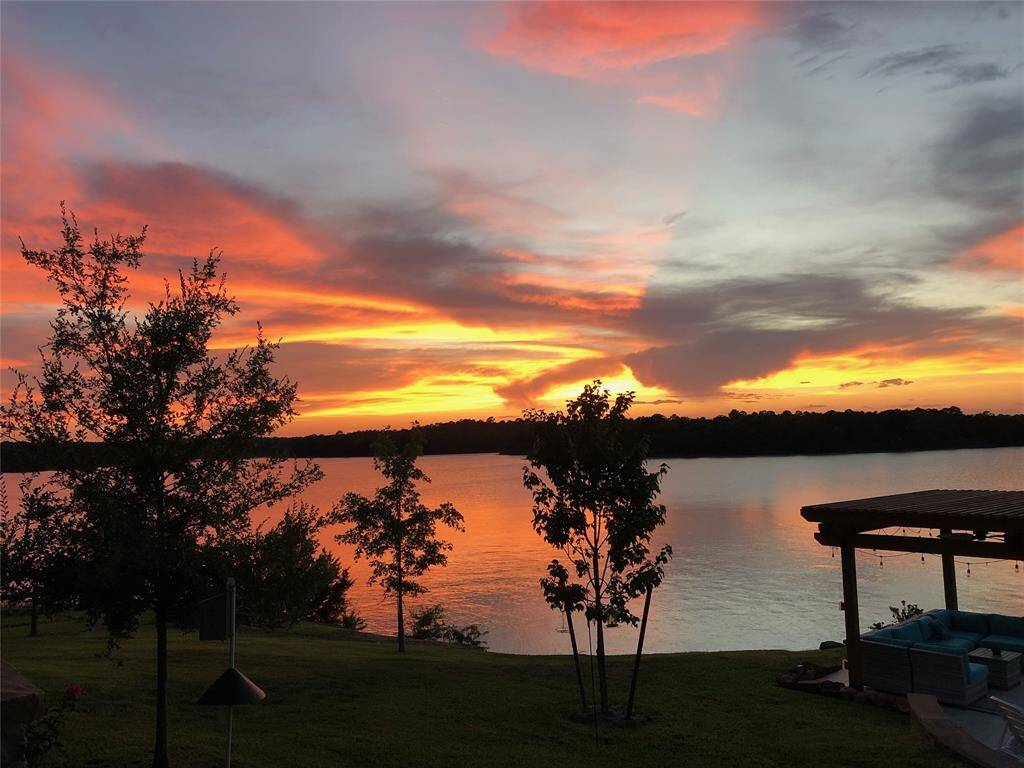 Watch the sky come alive with color as the sun sets over the lake. This unforgettable view can be enjoyed from your charming porch, poolside lounge, summer kitchen, or private boathouse. Every spot offers the perfect place to unwind and soak in the beauty of lakeside living.