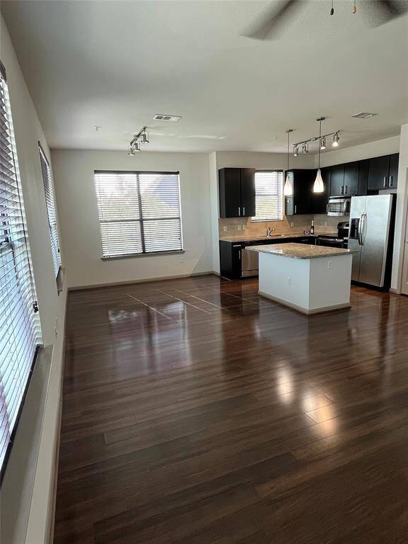 Corner unit with lots of windows, room for a dining table or desk! Stainless appliances and a dining island. Love the kitchen window over the sink!