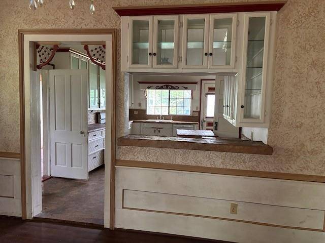 The pass through/serving bar and the door has so much charm with the gingerbread trim