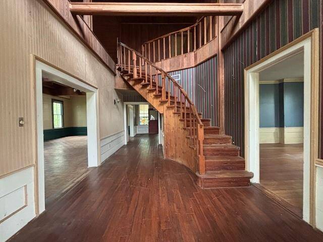 The winding stairway adds so much glam to this house. The spacious living area is to the left.