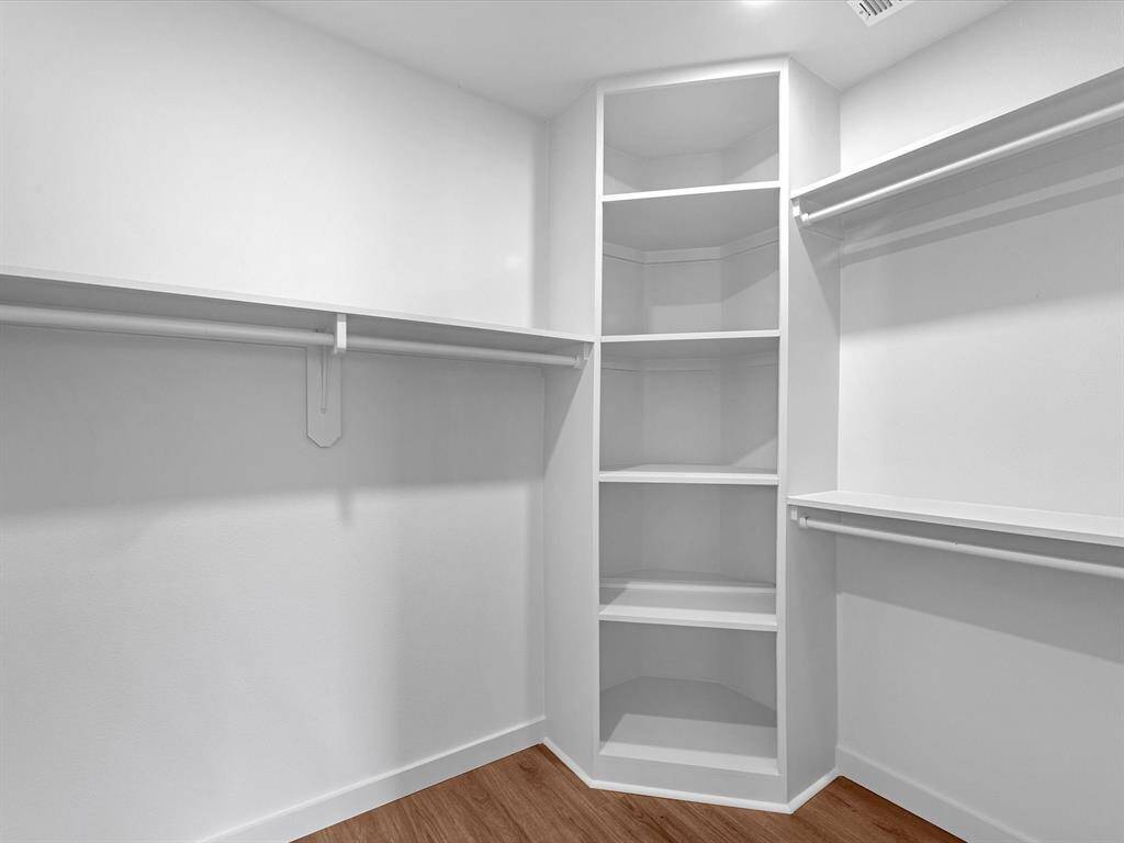Walk in closet in primary bedroom.