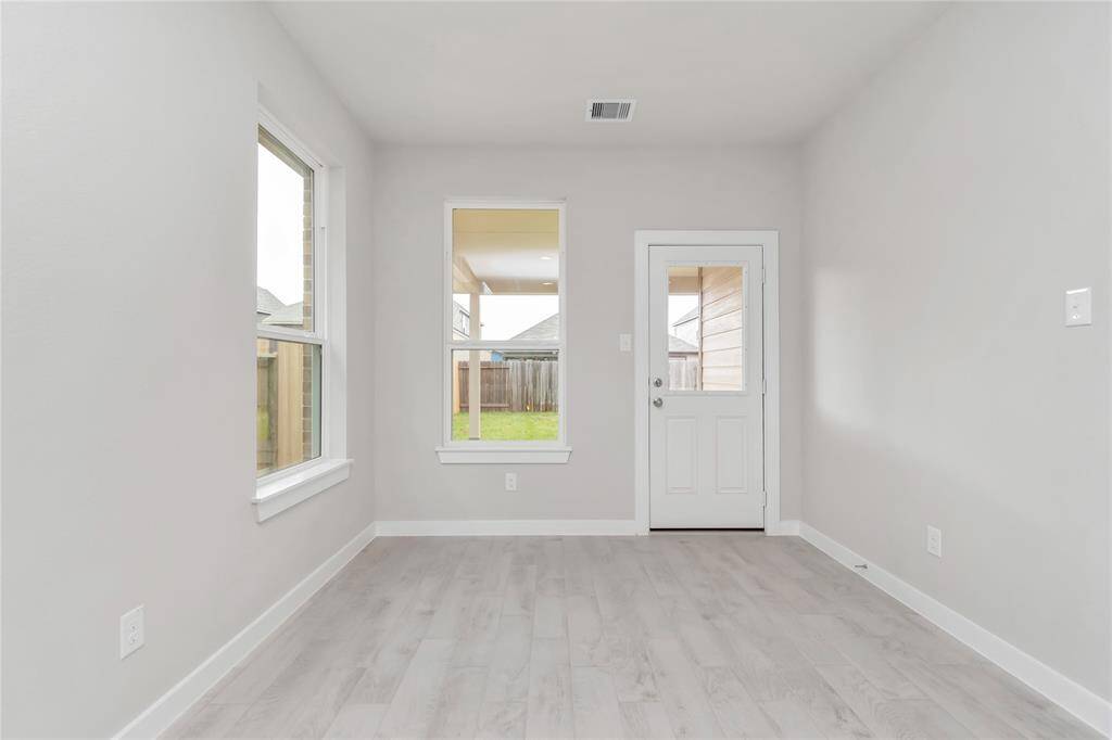 From breakfast area, step through the back door for a breath of fresh air onto the covered patio, extending your living space to the outdoors. Sample photo of completed home with similar floor plan. As-built interior colors and selections may vary