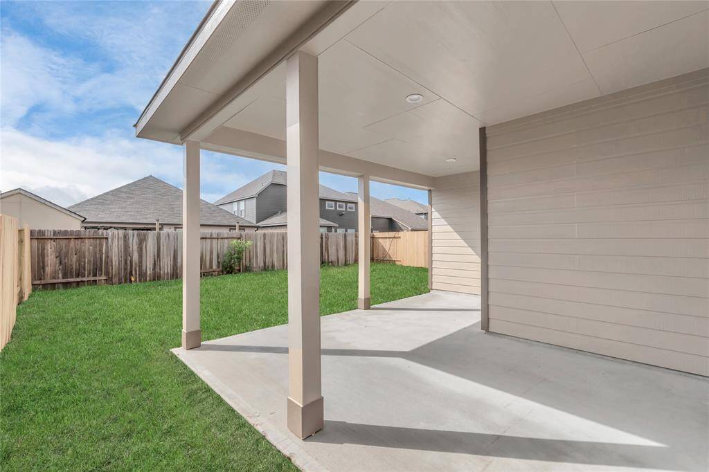 Step into a world of outdoor possibilities with this remarkable backyard and its charming covered patio. Sample photo of completed home with similar floor plan. As-built interior colors and selections may vary