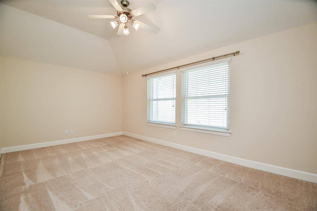 This creamy hued primary suite offers great natural light, lush carpeting and plenty of wall and floor space for your treasures.