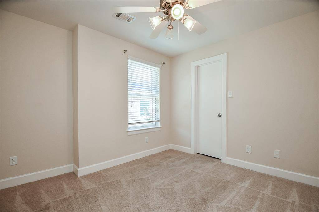 Natural light filters into a carpeted secondary bedroom. Any secondary can serve alternate purposes, such as a nursery, hobby room, home office? You decide!