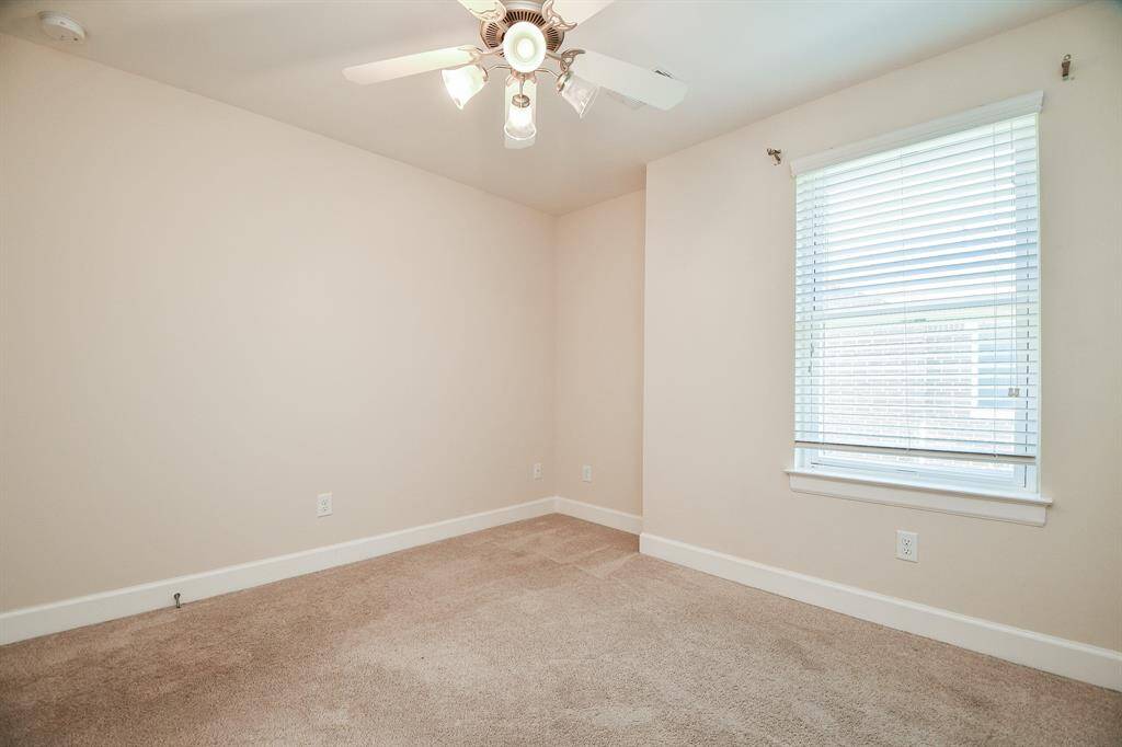 Natural light easily filters into this spacious secondary bedroom.