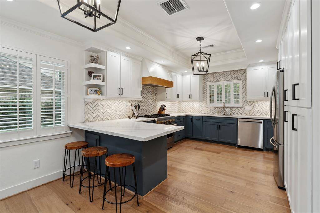 Open Kitchen with New Jenn-Air 36" dual fuel range, Jenn-Air Dishwasher, and Range hood insert.