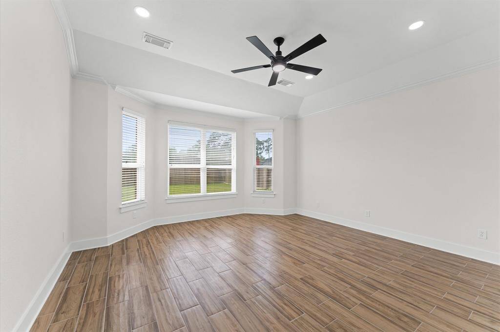 Primary Bathroom – Spa-like ensuite with a freestanding soaking tub, seamless glass shower, dual vanities, quartz countertops, and a massive walk-in closet.