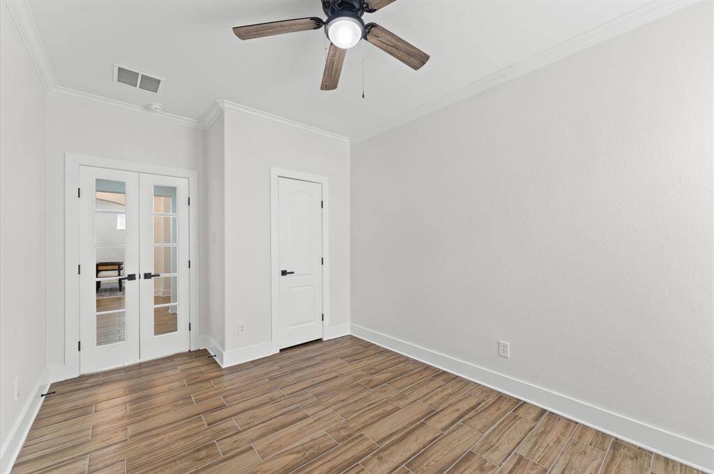Home office/study that could serve as a 6th bedroom, with a fully upgraded bath nearby.