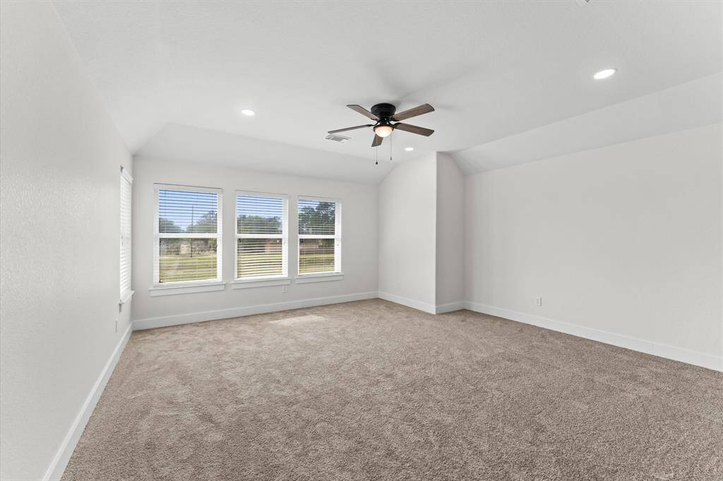 Spacious second-floor game room with plenty of natural light and endless possibilities for entertainment.