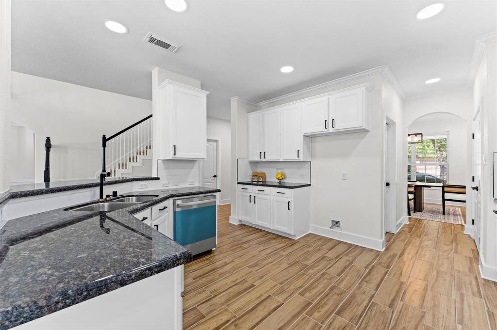 Completely remodeled with white shaker cabinetry, black hardware, quartz countertops, and brand-new stainless-steel appliances, including a 5-burner gas cooktop, Wi-Fi-enabled oven, and dishwasher.