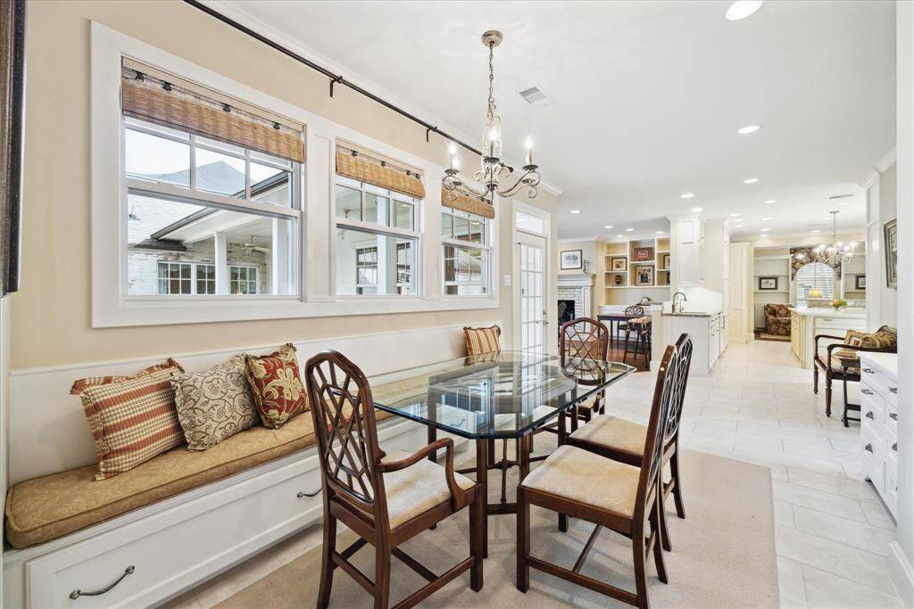 The bright and spacious Breakfast Area offers large windows with custom bamboo "matchstick" blinds, providing ample natural light and creating a welcoming atmosphere.