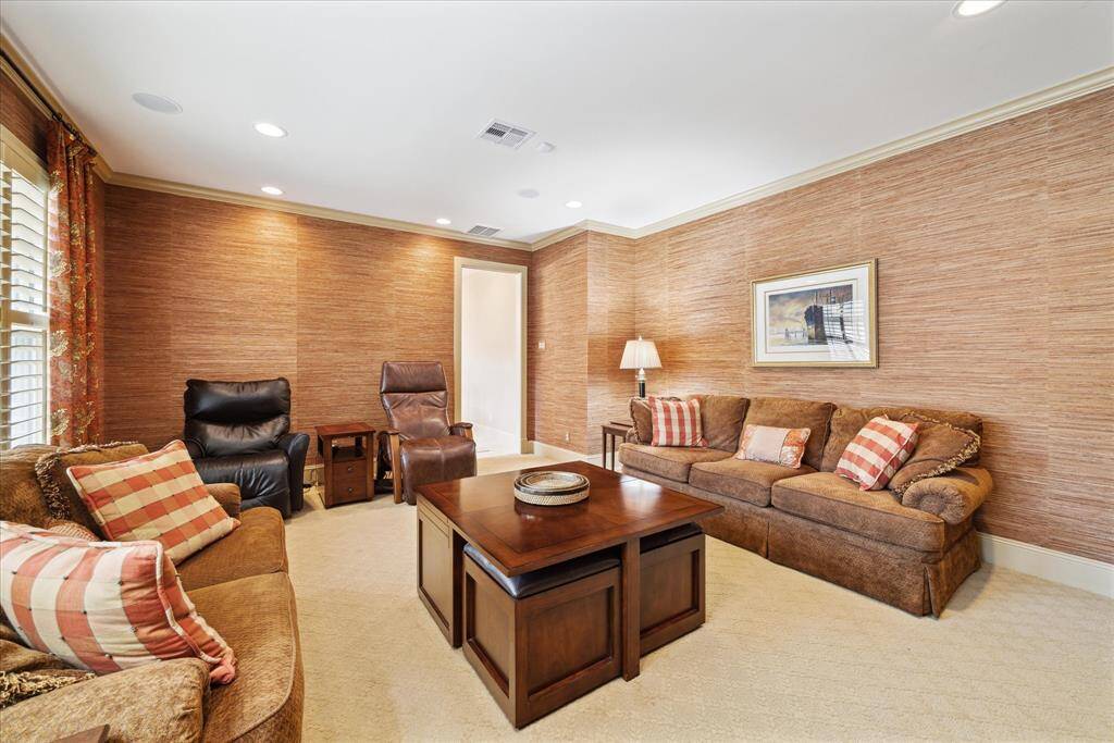 Off the breakfast area is the newly added Family Room, featuring warm, textured walls and neutral wall-to-wall carpeting.