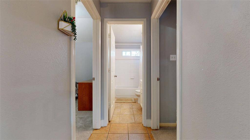1309 Bayswater, Primary bathroom, soft gray walls and dark gray cabinets with modern long mirror, stand up shower and jacuzzi