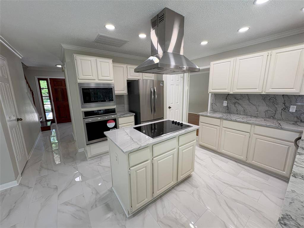 newly installed vent hood and double stainless steel oven in the kitchen