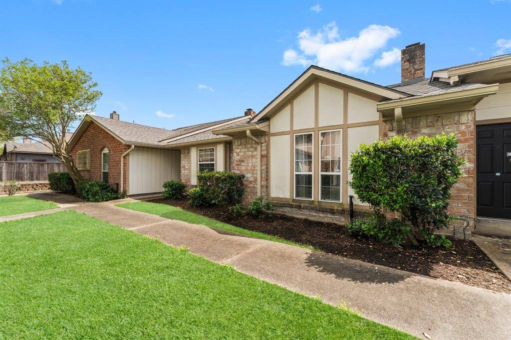 Charming condo with classic brick exterior and well-kept landscaping in a peaceful neighborhood.