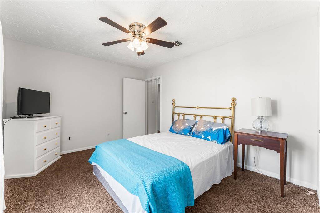 Comfortable guest bedroom, ceiling fan, and clean neutral tones—offering a cozy and welcoming atmosphere for visitors.