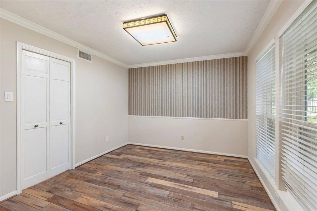 Study off of entry with doors that open to kitchen
